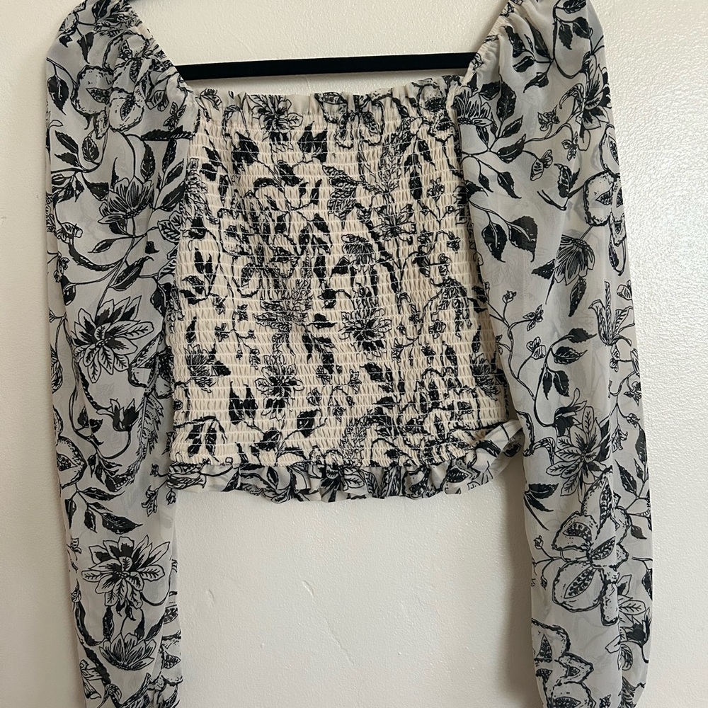 Small light yellow blouse with flowers.